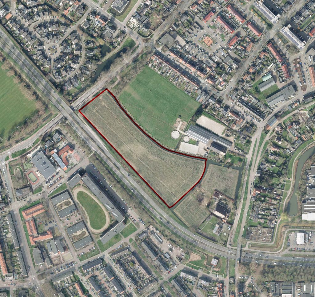 Luchtfoto van de geplande locatie voor flexwoningen in Ridderkerk, omlijnd in rood.